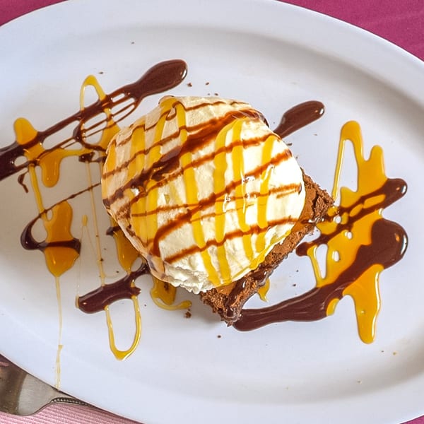 A P.S. Burgers brownie dessert with vanilla ice cream, drizzled with caramel and chocolate sauce.