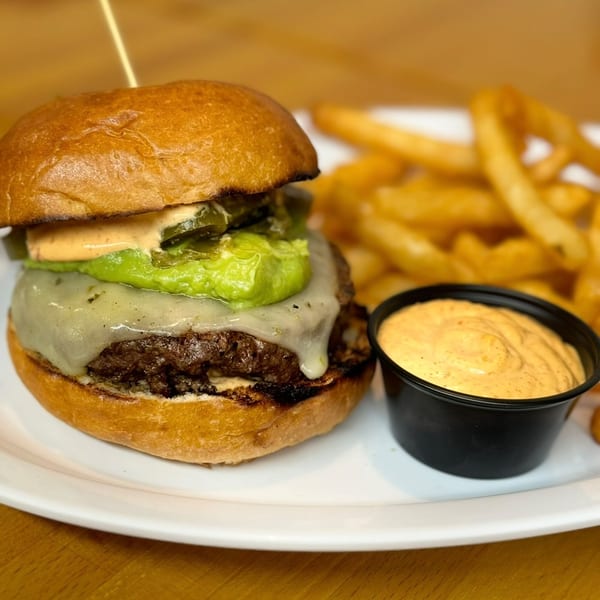 P.S. Burgers' cheeseburger with guacamole, jalapeños, and special sauce, served with fries and dipping sauce.